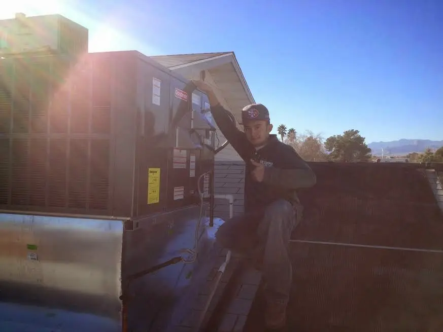 HVAC technician performing HVAC Inspection on a rooftop unit in San Jacinto